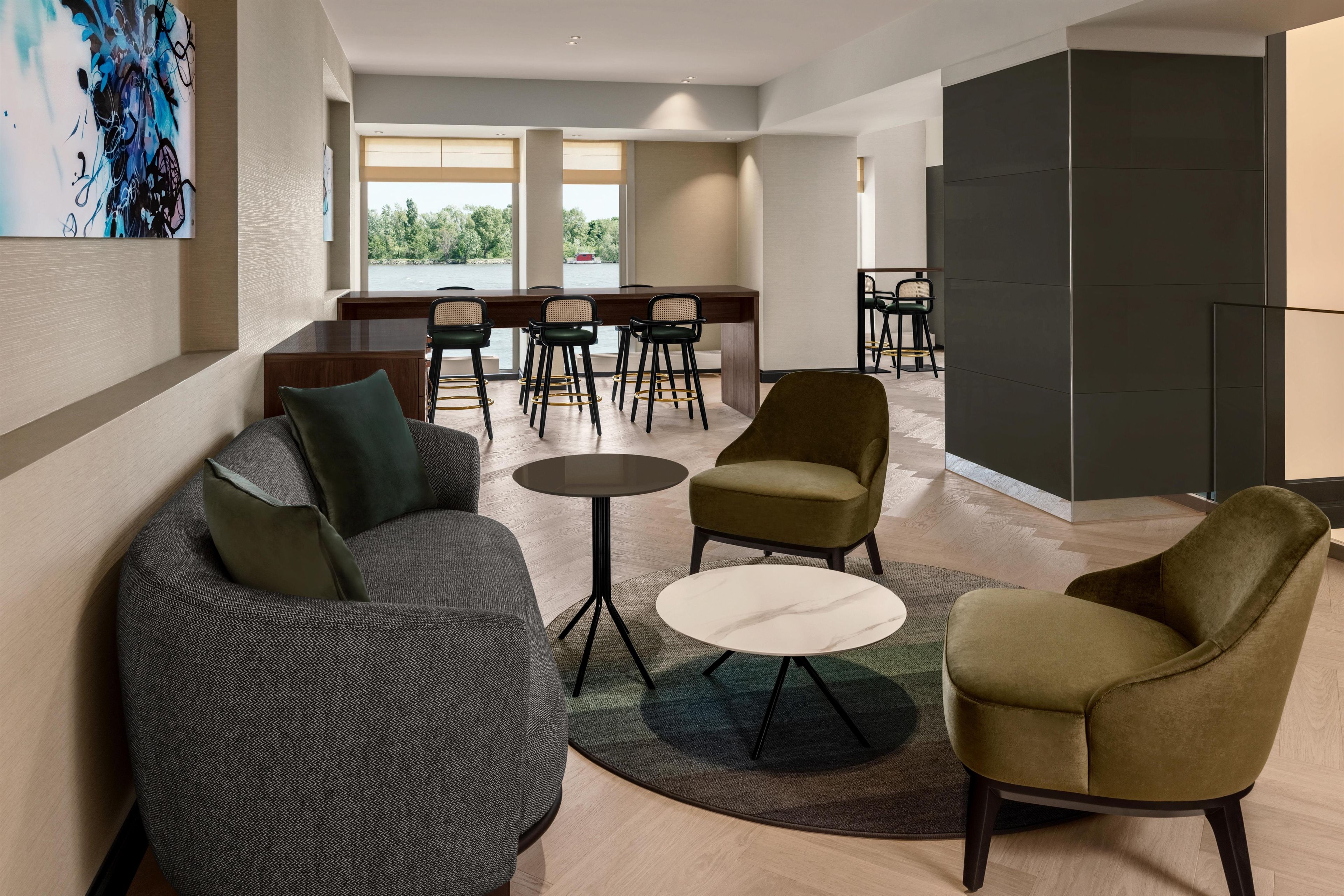 Een moderne lounge met zithoek, salontafel en uitzicht op het groen.