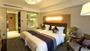 A hotel room with a large bed, bedside tables, a mirror, and a bathroom visible through an open door. - Hotel New Otani Chang Fu Gong (Beijing)