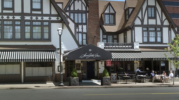 A traditional Tudor-style building with a black awning labeled "28 Sally's Inn." - Seven Gables, St. Louis West, a Tribute Portfolio Hotel (St. Louis)