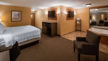 A hotel room with a bed, a desk, a chair, a TV, and a bathroom with a bathtub and sink.