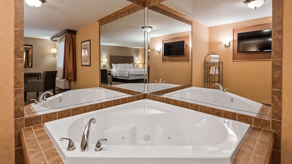 Suite, 1 King Bed, Non Smoking, Jetted Tub | Bathroom | Hair dryer, towels, soap, shampoo