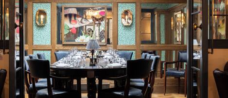A dining area with a round table set for six, surrounded by six chairs.