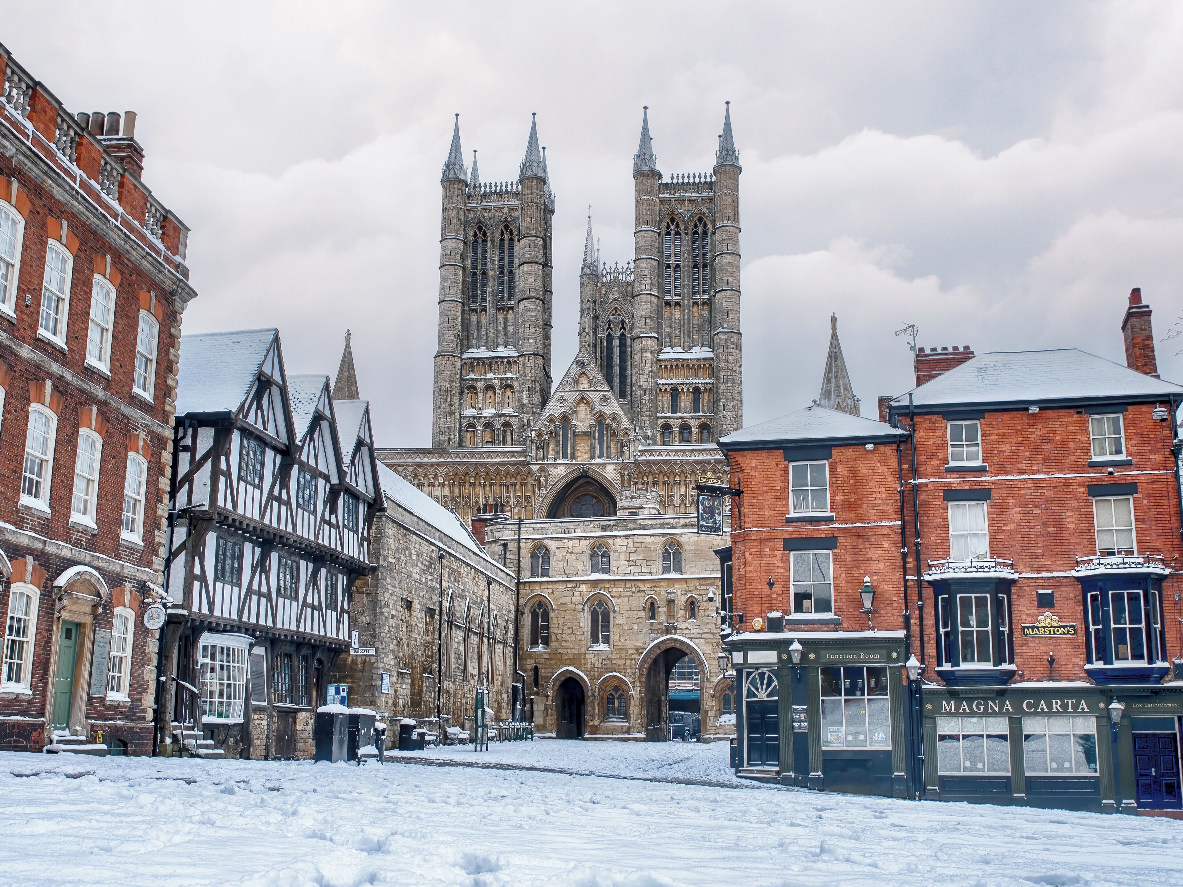 A historic building with Gothic architecture, including pointed arches and a large central tower.