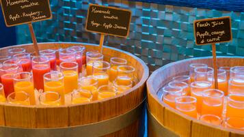 A juice bar with various homemade smoothies and fresh juice options.