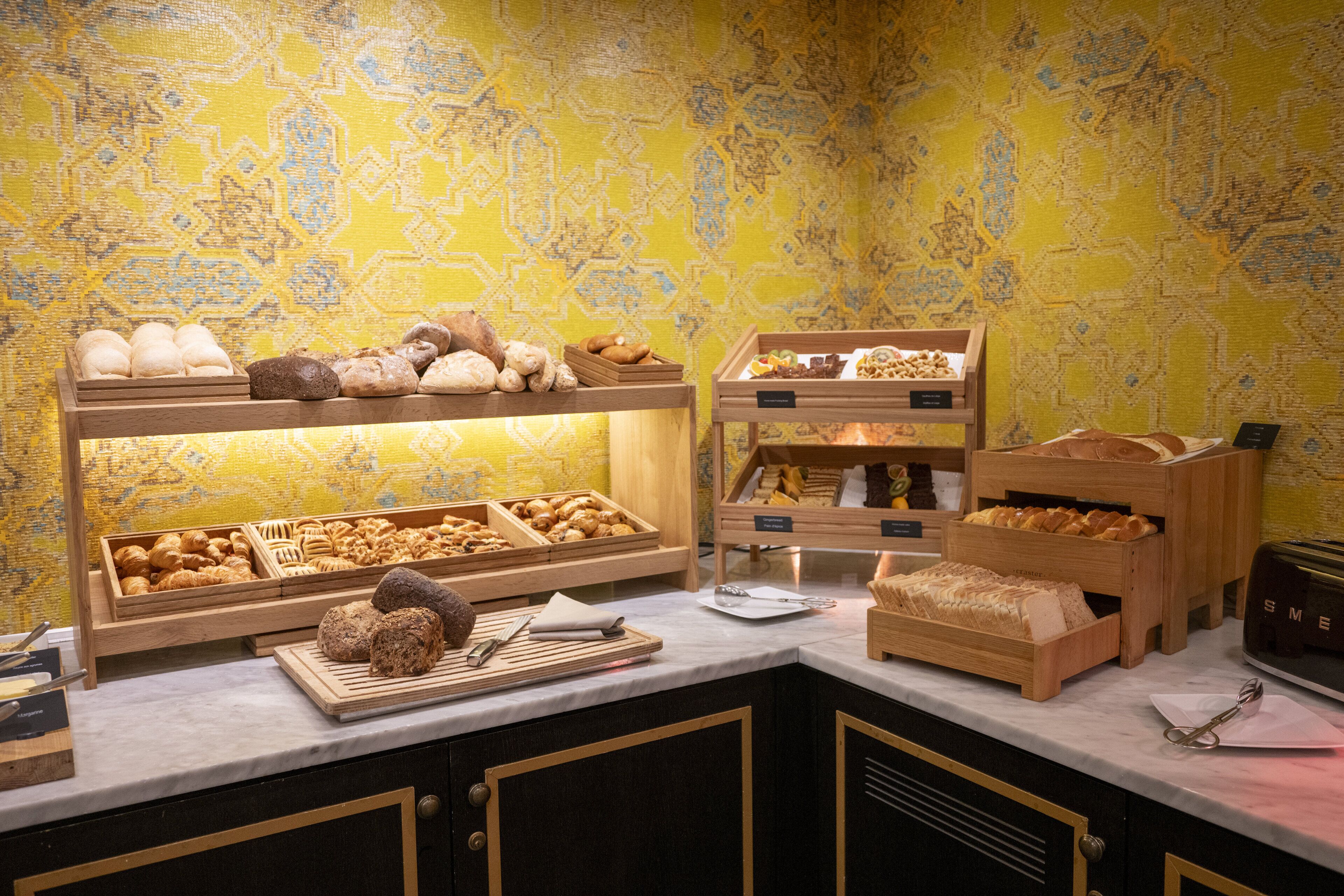 A bakery display with various baked goods and a toaster.