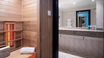 Relax in a spacious room with a large mirror, contemporary bathroom, and shower area.