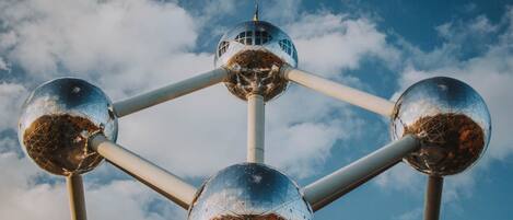 A metallic structure with spherical elements and a central hub, set against a clear sky.