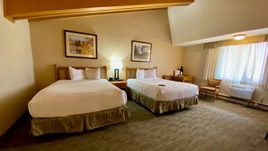 A hotel room with two beds, a desk, a chair, and a radiator. - Best Western Sheridan Center (Sheridan)