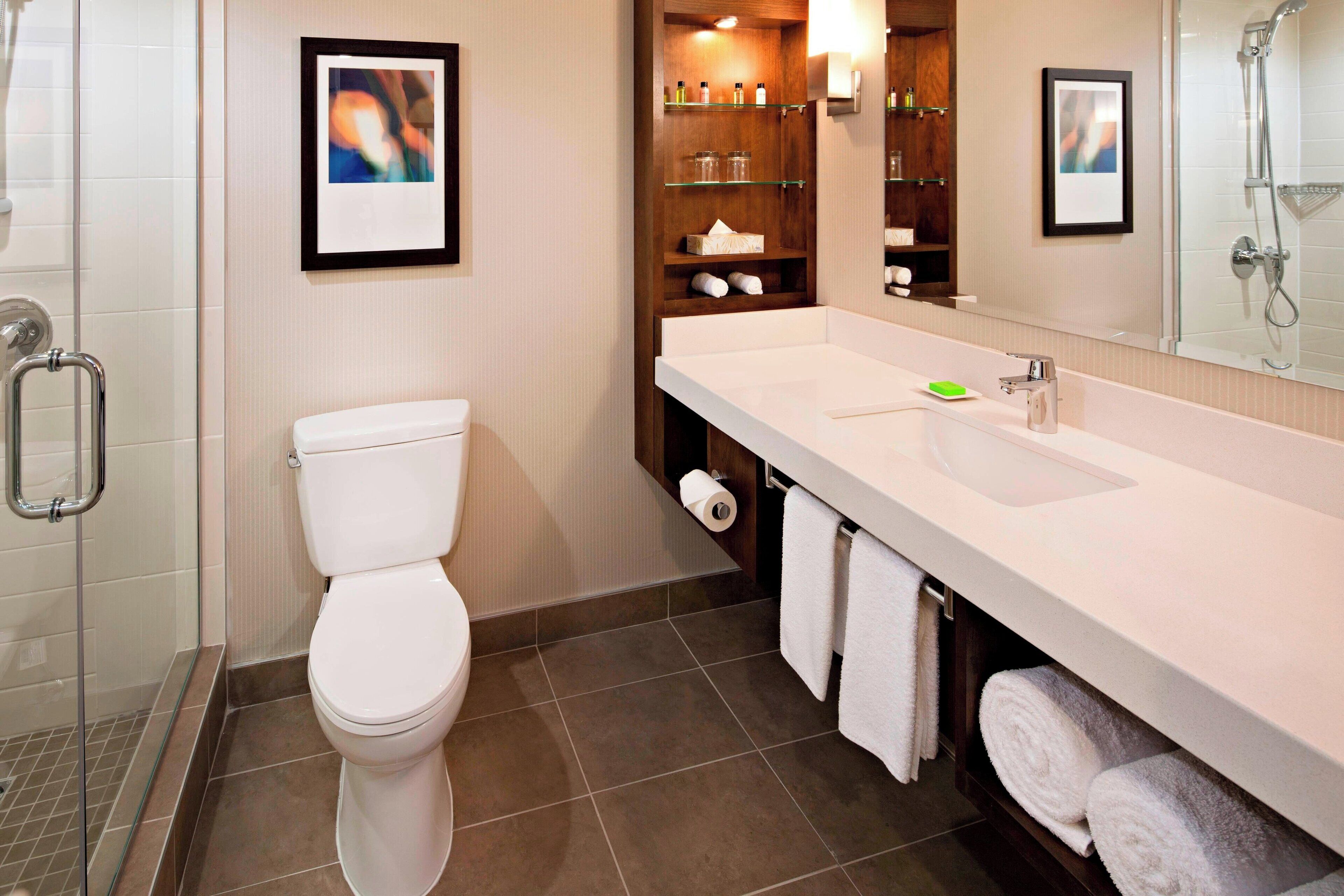 combined shower/bathtub, designer toiletries, hair dryer, towels