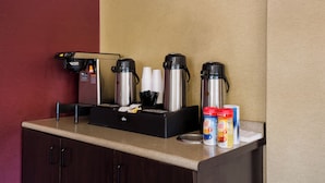 A coffee station with a coffee machine, disposable cups, and coffee pods. - Red Roof Inn Wilkes-Barre Arena (Wilkes-Barre)