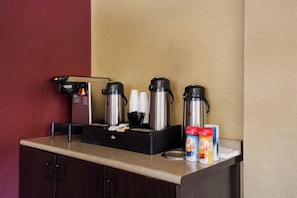 A coffee station with a coffee machine, disposable cups, and coffee pods. - Red Roof Inn Wilkes-Barre Arena (Wilkes-Barre)