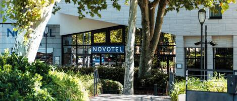 A modern building with a sign reading 'NOVOTEL' indicating a hotel.