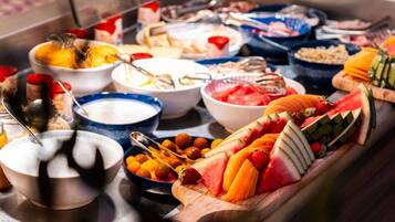 A buffet with various food items and utensils.