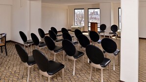 A conference room with rows of black chairs and a carpeted floor. - Quality Inn & Suites Matteson near I-57 (Matteson)