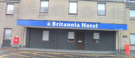 A building with a sign reading "Britannia Hotel" above the entrance.
