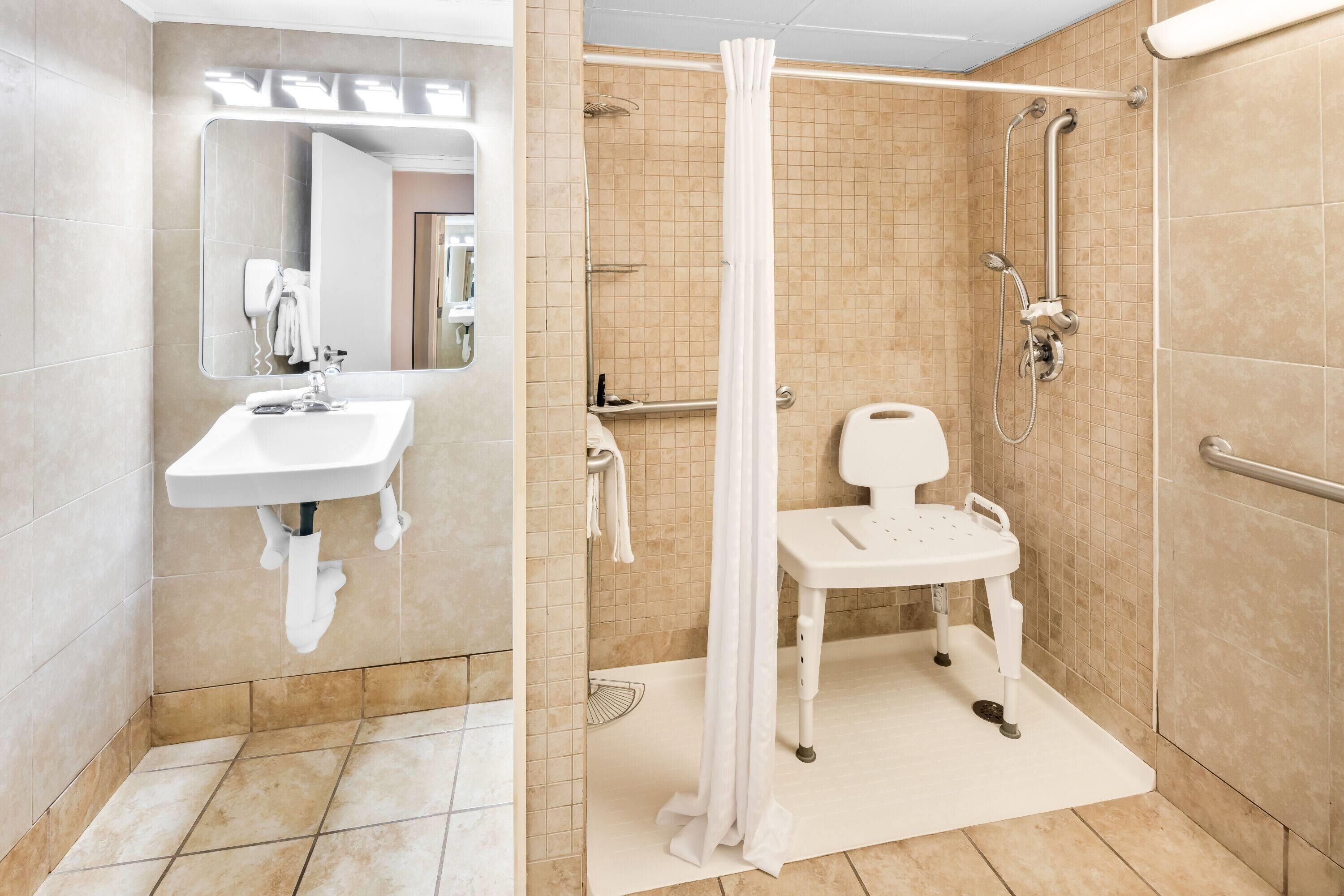 A modern bathroom with a shower, a toilet, and a sink.