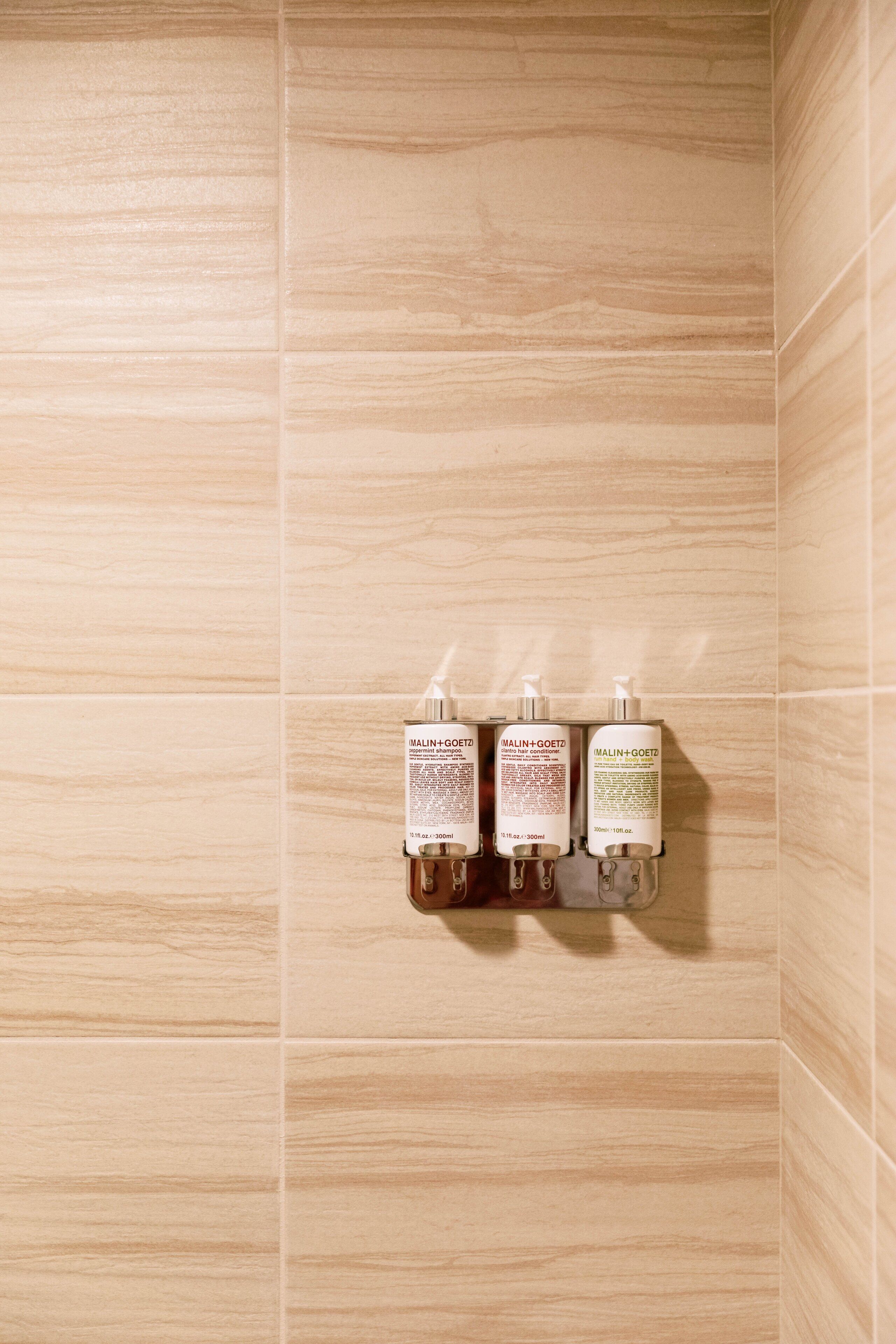 combined shower/bathtub, designer toiletries, hair dryer, bathrobes