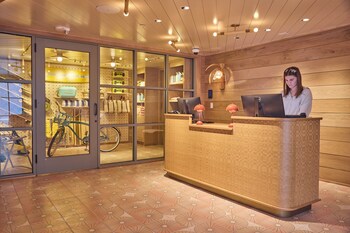 A fitness room with elliptical machines and a stationary bike, equipped with screens for entertainment. at The Ryder Hotel