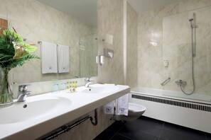 Enjoy a refreshing shower in the bathroom with a dual sink vanity and toilet.