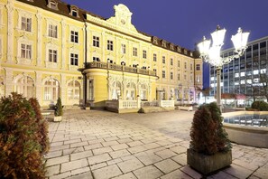 Experience the grandeur of Park Hotel Maximilian, set amidst a beautifully manicured courtyard with a tranquil fountain.