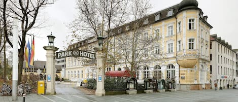 A historic building with a sign reading "Park Hotel."
