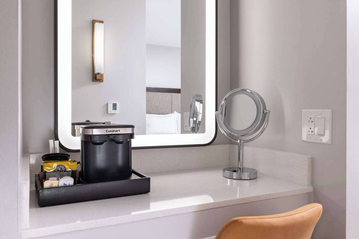 Badkamer | Een bad/douchecombinatie, designer toiletartikelen, een haardroger