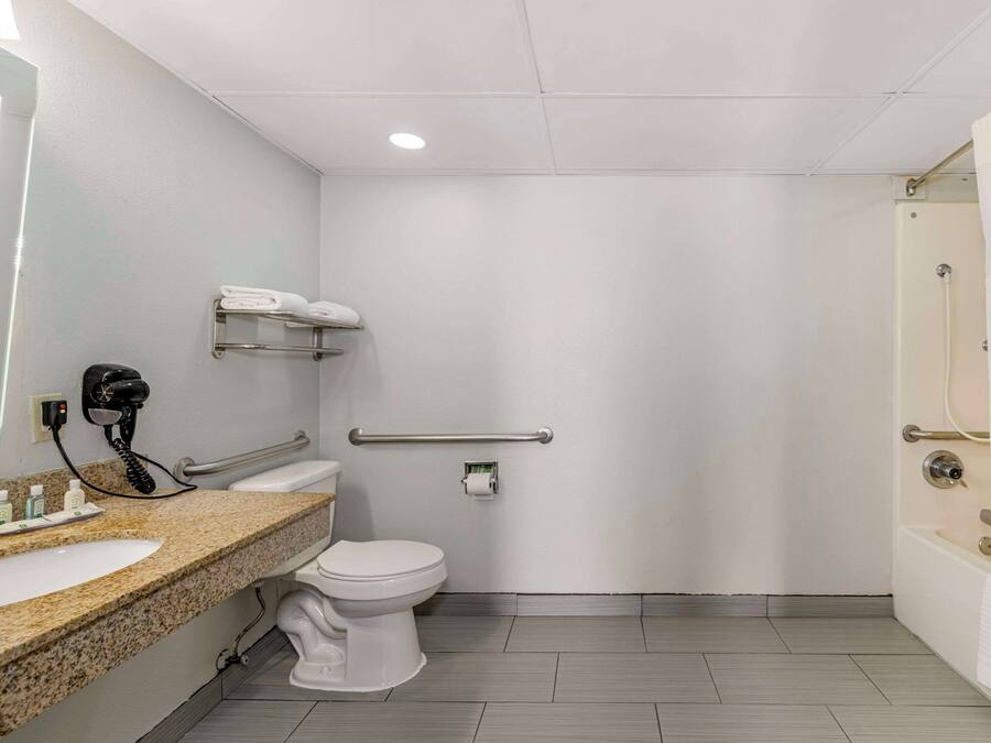 A bathroom with a sink, toilet, and shower.