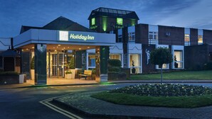 A Holiday Inn hotel with a modern design, featuring a prominent entrance and a rooftop structure. - Holiday Inn Leeds Garforth by IHG (Leeds)