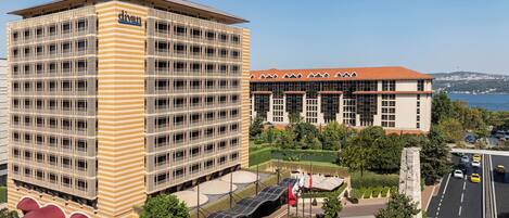 A modern hotel with a distinctive striped facade and a rooftop terrace.