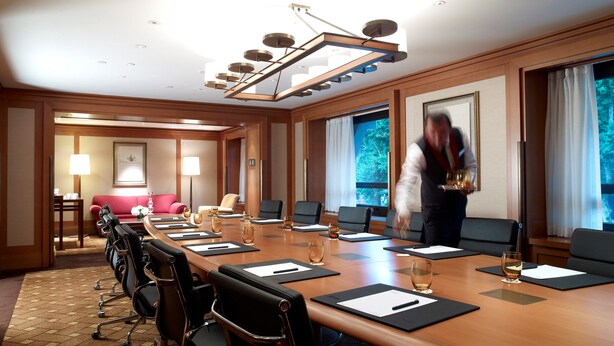 A conference room with a long table, multiple chairs, and a modern chandelier. - Divan Istanbul (Istanbul)