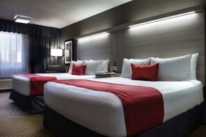 A hotel room with two beds, a desk, and a chair. - Coast Calgary University Area Hotel by APA (Calgary)