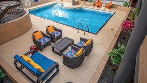 An indoor swimming pool with lounge chairs and a staircase. - Coast Calgary University Area Hotel by APA (Calgary)