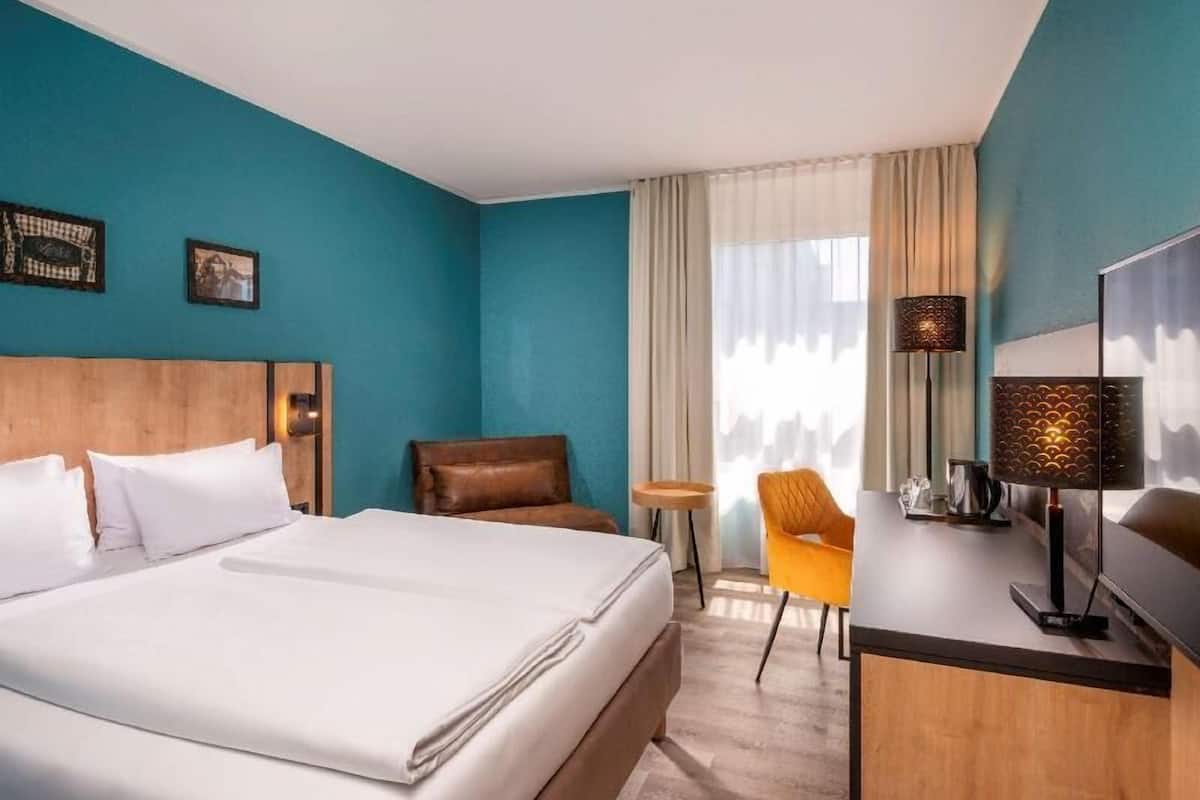 Ropa de cama hipoalergénica y caja de seguridad en la habitación