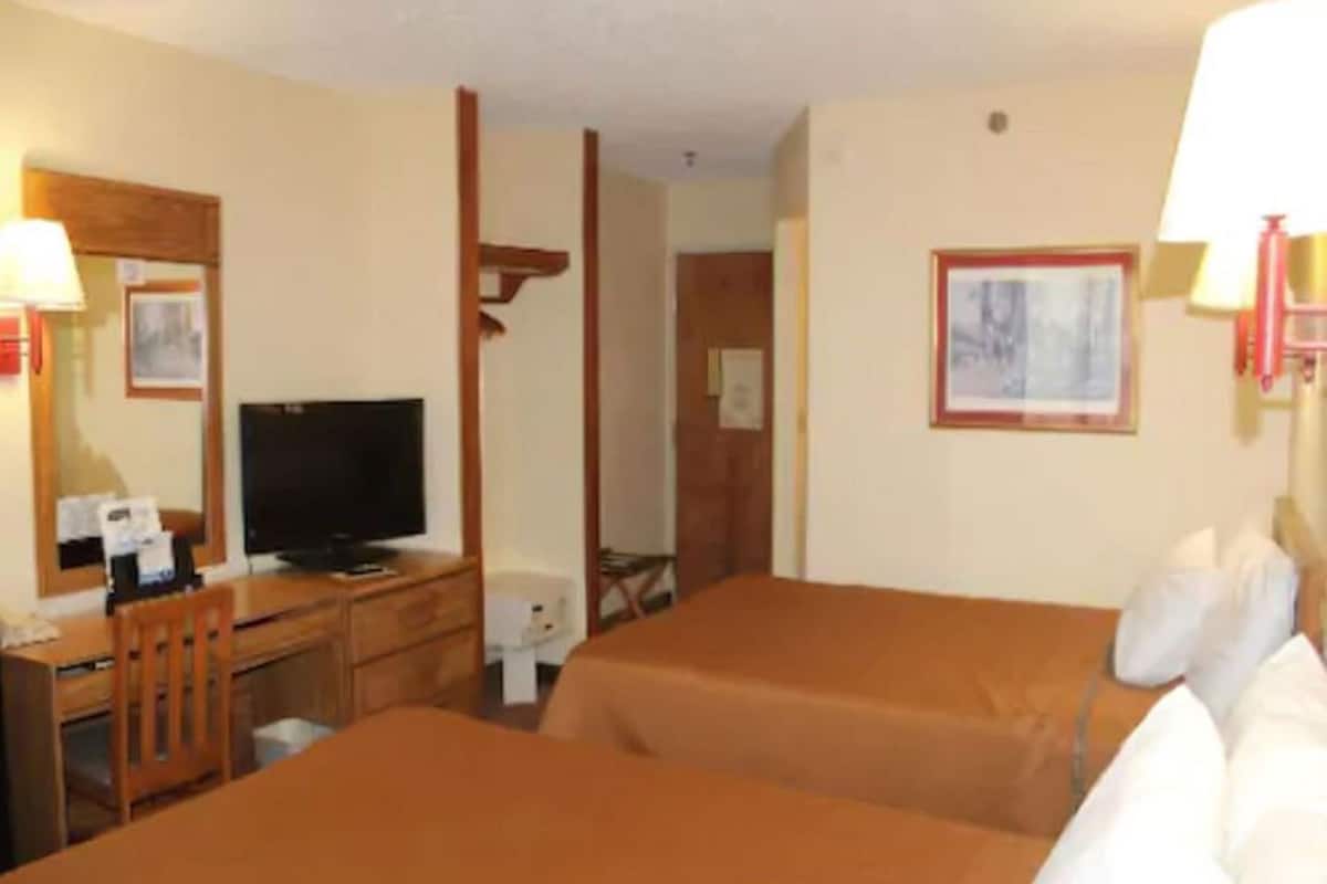 Premium bedding, desk, laptop workspace, soundproofing