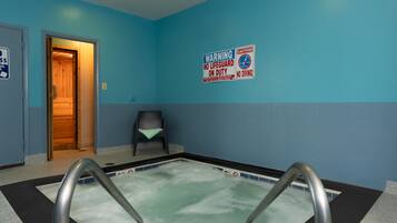 Swimmers can enjoy the pool with metal handrails, surrounded by a black and white checkered floor.