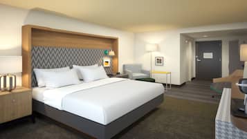 Ein Hotelzimmer mit einem großen Bett, einem Nachttisch mit Lampe, einem Schreibtisch mit Stuhl und einer Tür zu einem anderen Raum.