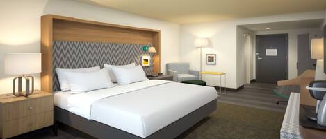 A hotel room with a large bed, a nightstand with a lamp, a desk with a chair, and a door leading to another room.