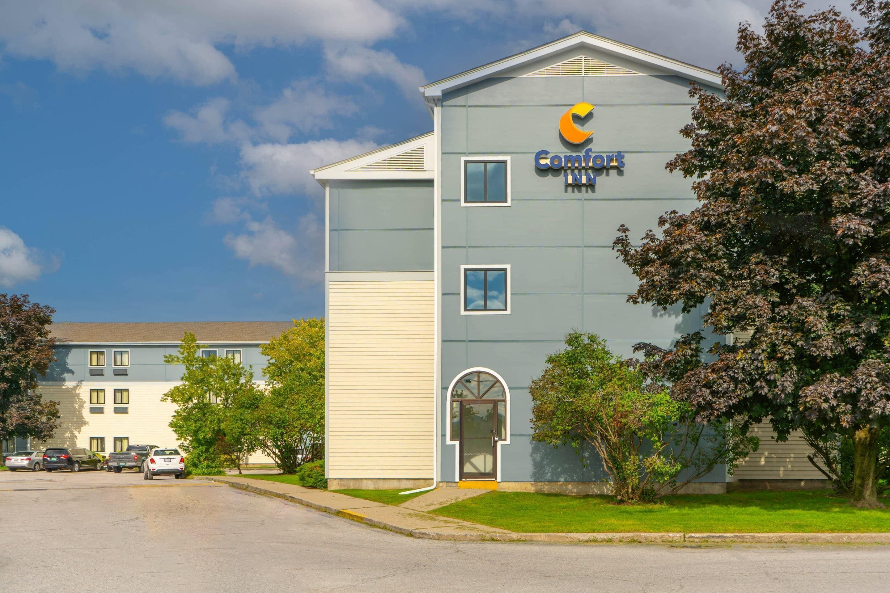 A hotel with a modern design, featuring a prominent logo on the facade.