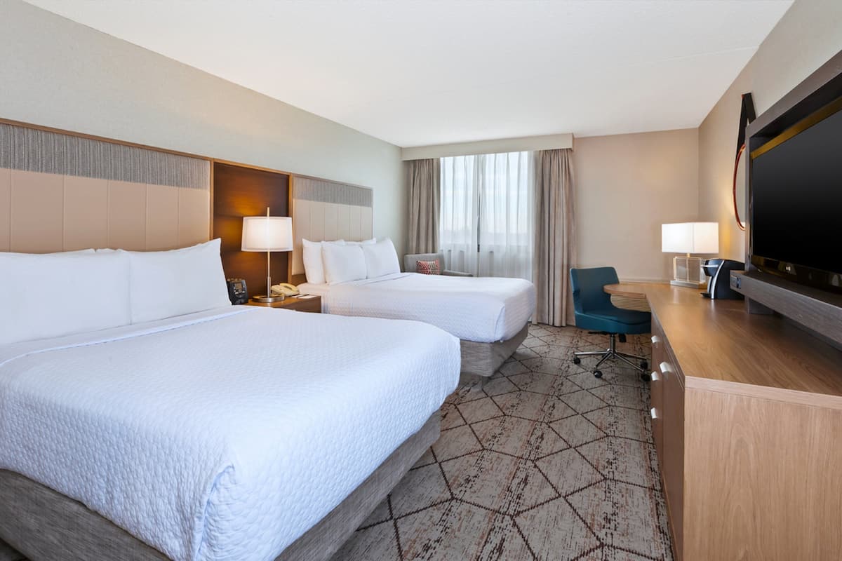 Hypo-allergenic bedding, desk, laptop workspace, blackout drapes