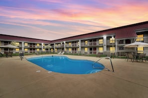 Seasonal outdoor pool, open 10:00 AM to 10:00 PM, pool umbrellas