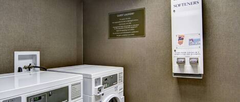 A guest laundry area with a sign indicating the use of Tide and Bounce detergents.