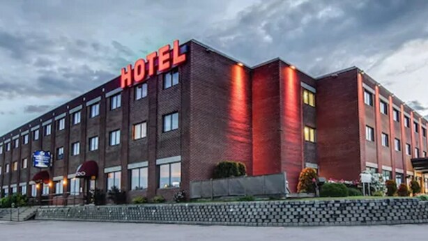 A multi-story hotel building with a prominent "HOTEL" sign on the facade.