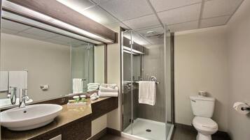 Une salle de bain moderne avec une douche à parois de verre, un lavabo et des toilettes.