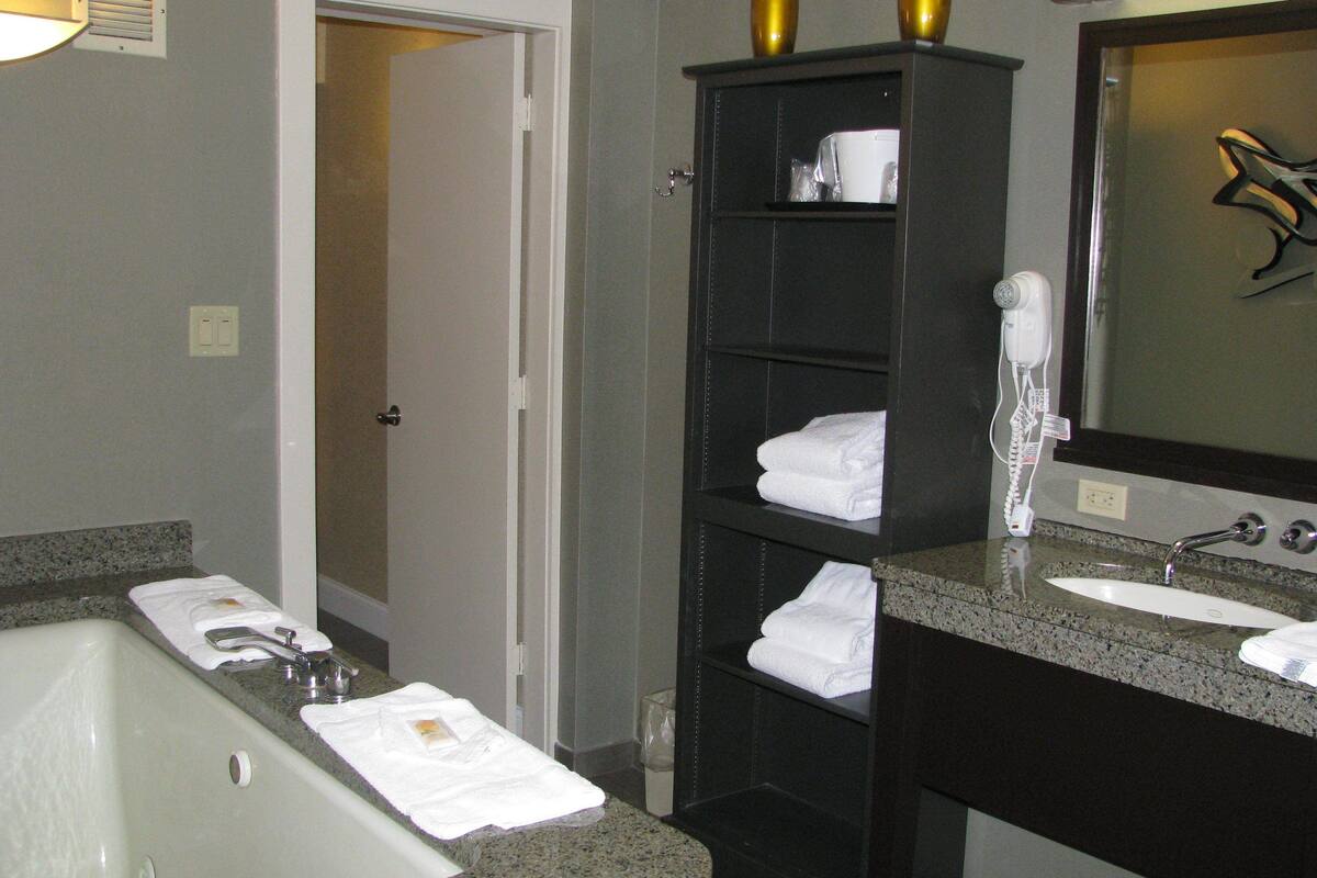 suite, 1 king bed | bathroom | free toiletries, hair dryer, towels