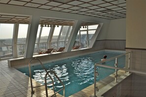 Indoor pool, open 9:00 AM to 9:00 PM, pool loungers