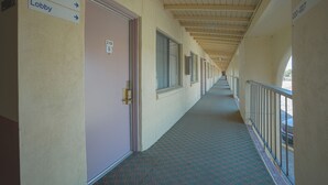 Een gang met deuren genummerd 219–201 en 220–227, die uitkomt in een lobby.