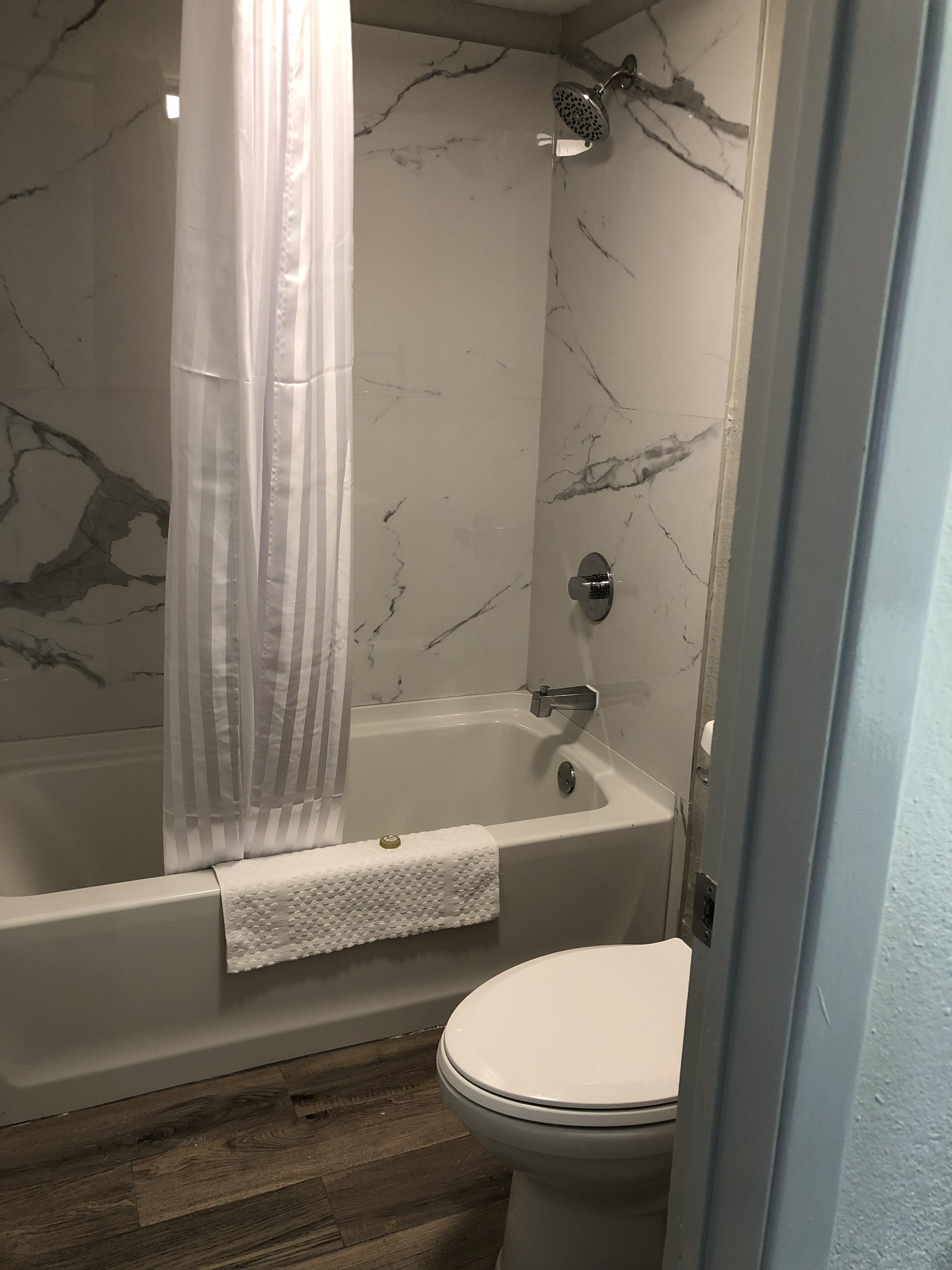Une salle de bain avec une baignoire, une douche et des toilettes.