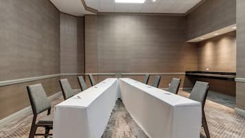 Conference room with a long table and comfortable seating for meetings and discussions.