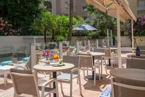 Seasonal outdoor pool, open 9:00 AM to 9:00 PM, pool umbrellas