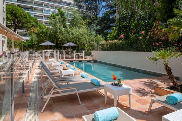 Seasonal outdoor pool, open 9:00 AM to 9:00 PM, pool umbrellas